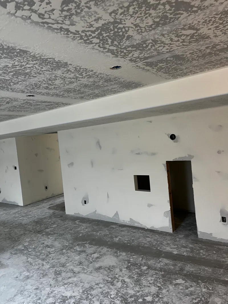 Basement finishing work with completed drywall and paint